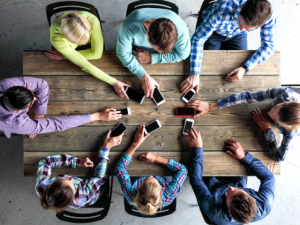 Stand out from the crowd of people gathered around table.